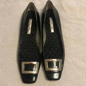 Enzo Angioloni patent leather shoes with silver buckle.